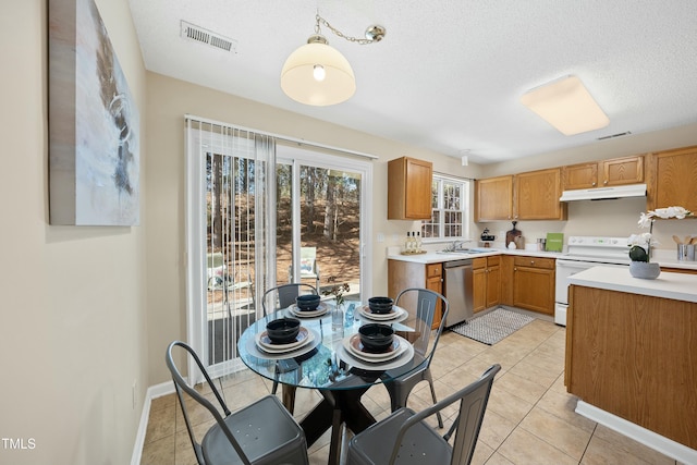 kitchen featuring white range with electric cooktop, dishwasher, sink, and light tile patterned floors