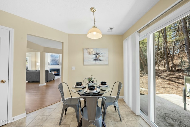 tiled dining room with a textured ceiling