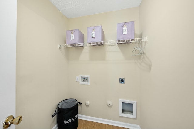 washroom with gas dryer hookup, hookup for a washing machine, wood-type flooring, a textured ceiling, and hookup for an electric dryer