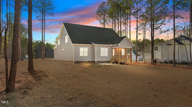 view of back house at dusk