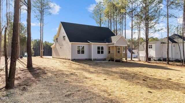 back of house with a lawn