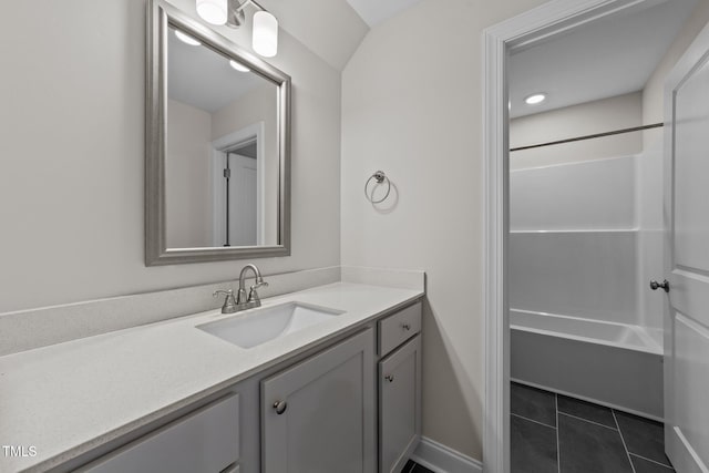 bathroom with tile patterned floors, vanity, and  shower combination