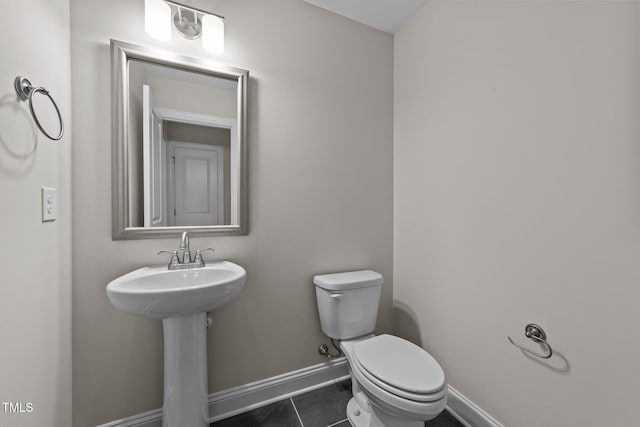 bathroom with sink, tile patterned floors, and toilet