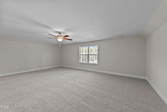 spare room with vaulted ceiling, ceiling fan, and carpet floors