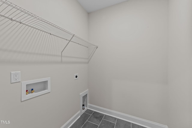 washroom with hookup for an electric dryer, hookup for a washing machine, and dark tile patterned floors