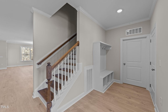 mudroom with crown molding and light wood-type flooring