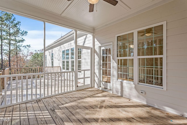 unfurnished sunroom featuring ceiling fan