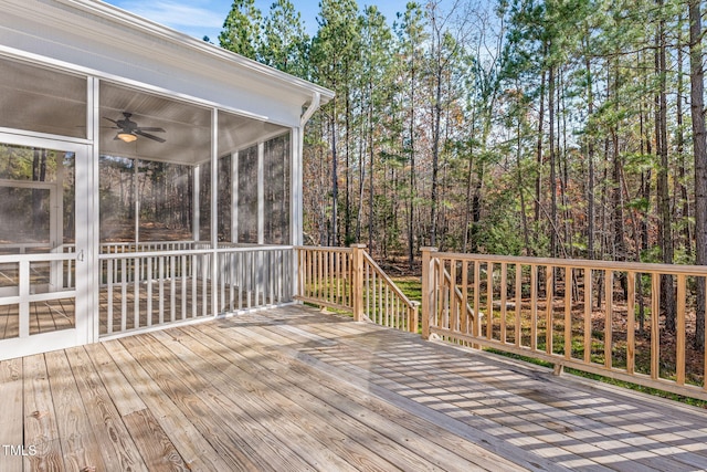 wooden terrace with ceiling fan and a sunroom