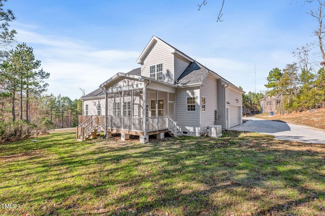 view of front facade with a front lawn, a sunroom, and a garage