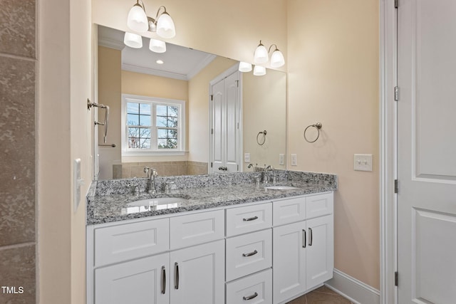 bathroom with ornamental molding, tile patterned floors, and vanity