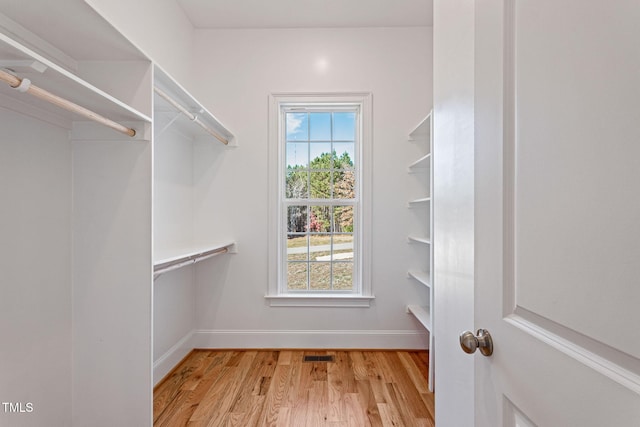 spacious closet with light hardwood / wood-style floors