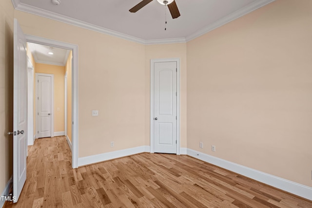 spare room featuring ornamental molding, ceiling fan, and light wood-type flooring