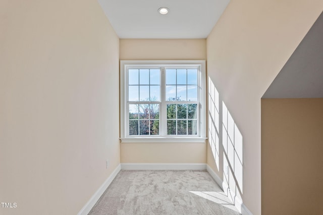 unfurnished room featuring light carpet