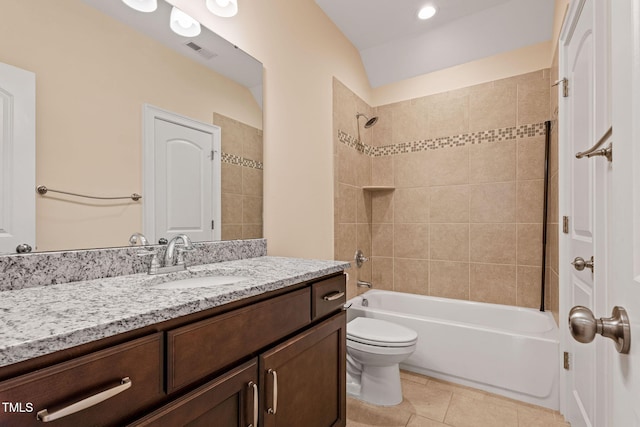 full bathroom featuring toilet, vaulted ceiling, tile patterned flooring, tiled shower / bath, and vanity