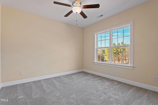 carpeted spare room featuring ceiling fan