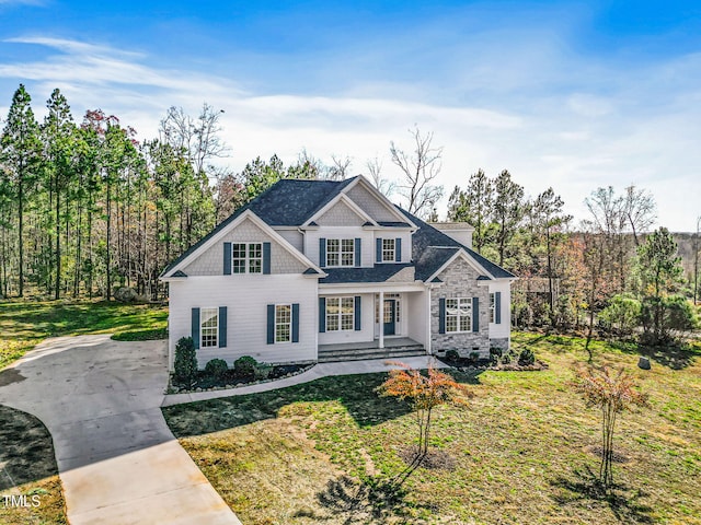 view of front of property featuring covered porch and a front lawn