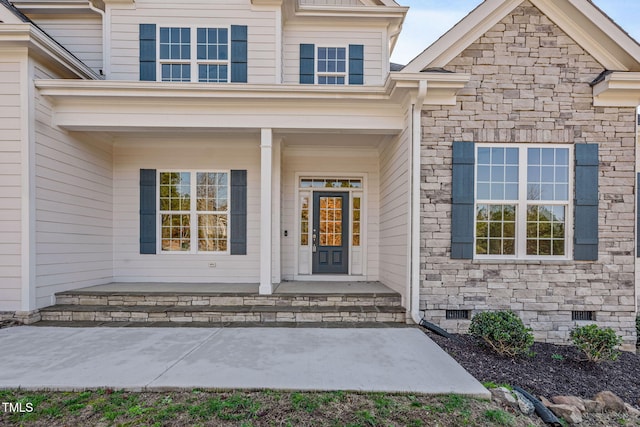 doorway to property featuring covered porch