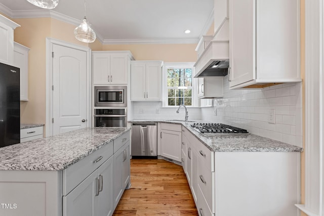 kitchen featuring white cabinetry, pendant lighting, crown molding, and appliances with stainless steel finishes