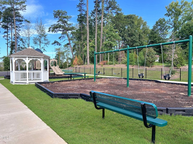 exterior space featuring a lawn, fence, playground community, and a gazebo