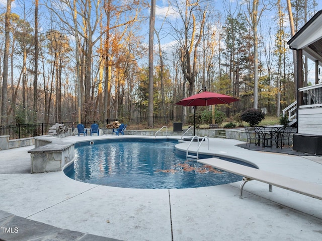 view of pool with a patio, central AC, and a diving board