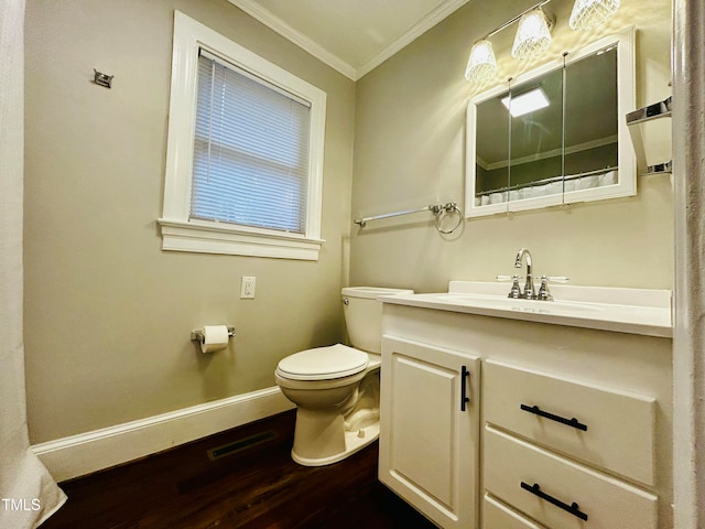 bathroom with crown molding, hardwood / wood-style floors, vanity, and toilet