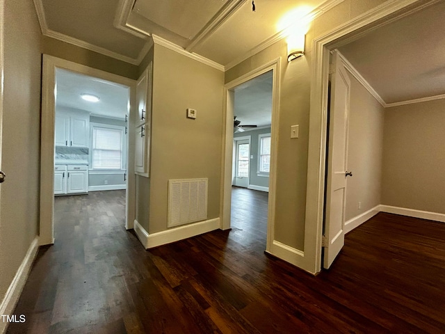 hall with dark hardwood / wood-style flooring and ornamental molding