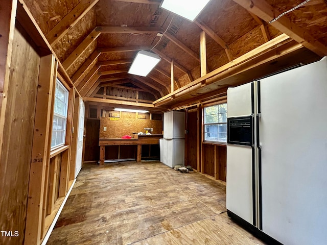 miscellaneous room with a workshop area and lofted ceiling