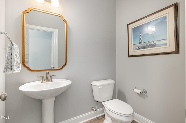 bathroom featuring hardwood / wood-style floors and toilet