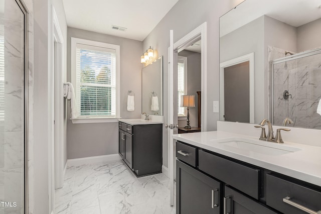 bathroom with vanity and a shower with shower door