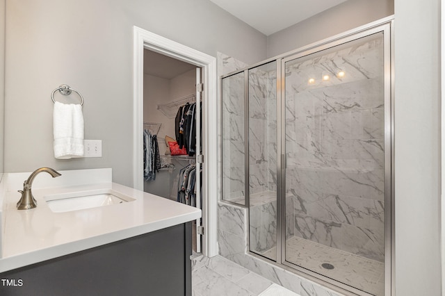 bathroom with a shower with door and vanity