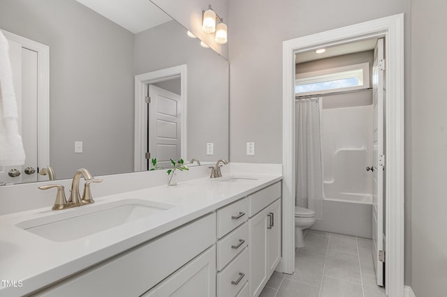 bathroom with tile patterned flooring, vanity, and toilet