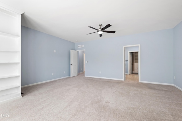 unfurnished bedroom featuring a ceiling fan, baseboards, light colored carpet, and visible vents