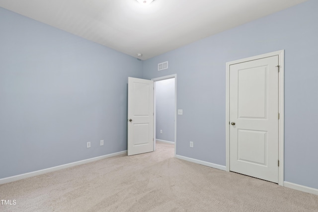 unfurnished bedroom with baseboards, carpet flooring, and visible vents