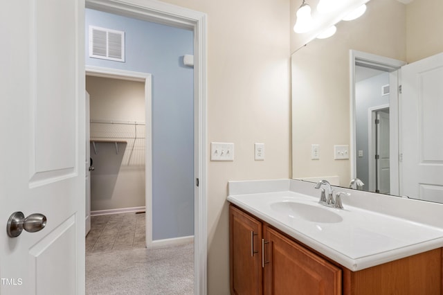 bathroom with visible vents, baseboards, and vanity