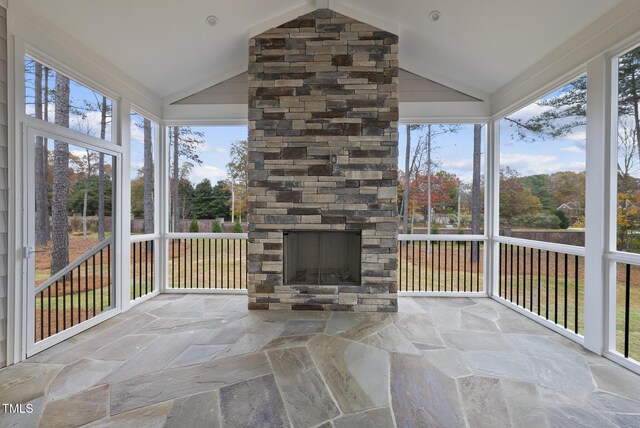 2637 Trifle Ln, Wake Forest, NC 27587 - unfurnished sunroom with stone finish floors, plenty of natural light, and high vaulted ceiling