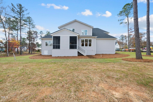 back of house with a yard and a sunroom