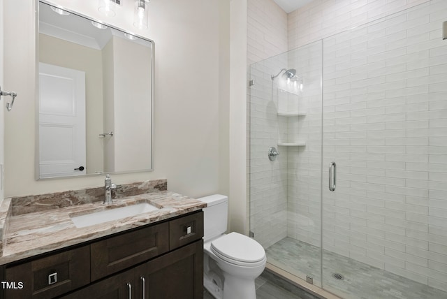 bathroom with an enclosed shower, vanity, toilet, and ornamental molding