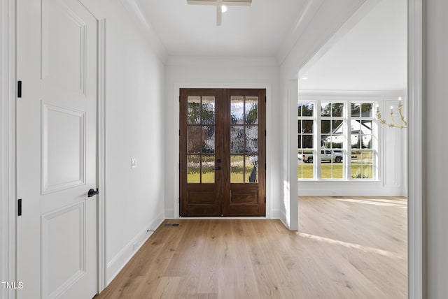 2637 Trifle Ln, Wake Forest, NC 27587 - entrance foyer with french doors, wood finished floors, baseboards, healthy amount of natural light, and ornamental molding