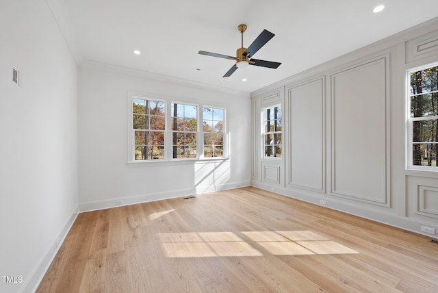 empty room featuring light hardwood / wood-style floors, ceiling fan, and ornamental molding