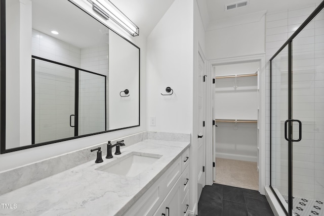 2637 Trifle Ln, Wake Forest, NC 27587 - bathroom featuring vanity, a walk in closet, a shower stall, tile patterned flooring, and recessed lighting