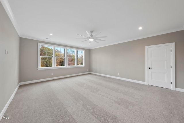 empty room featuring light colored carpet, ceiling fan, and ornamental molding