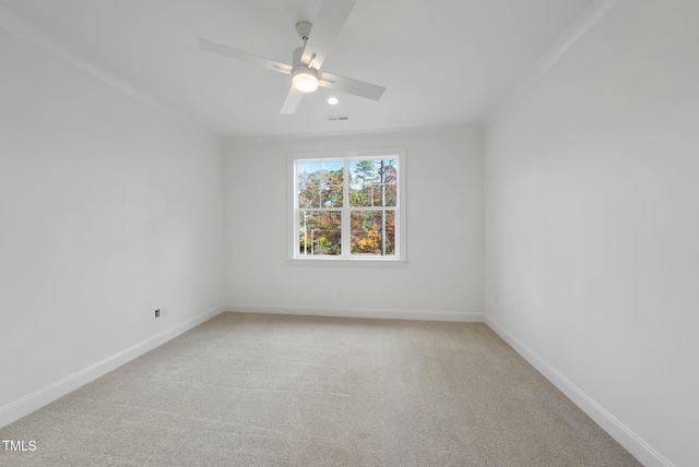 spare room with carpet, ceiling fan, and ornamental molding