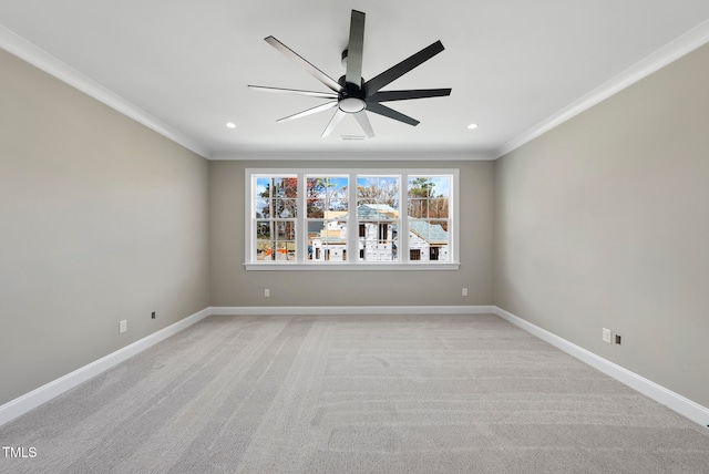 carpeted empty room with ceiling fan and ornamental molding