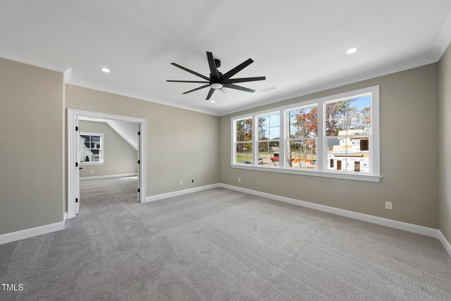 spare room with ceiling fan, light colored carpet, and ornamental molding