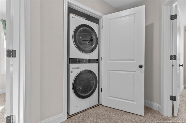 laundry room with stacked washer / dryer