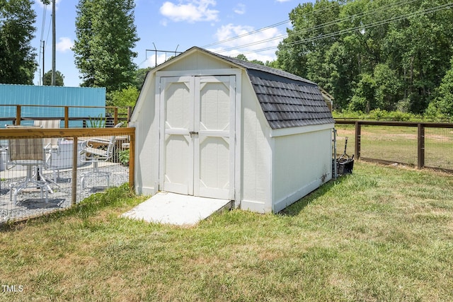 view of outdoor structure featuring a lawn