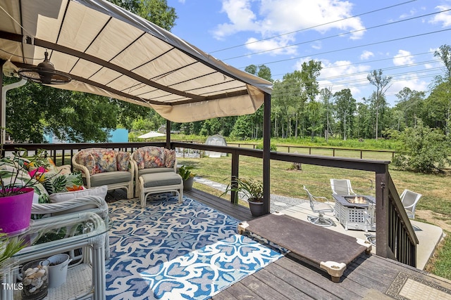 wooden terrace featuring a fire pit