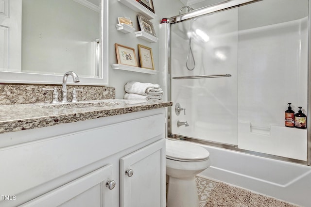 full bathroom featuring shower / bath combination with glass door, crown molding, vanity, and toilet