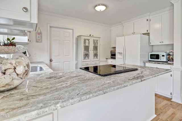 kitchen featuring white cabinets, light wood-type flooring, white appliances, and ornamental molding