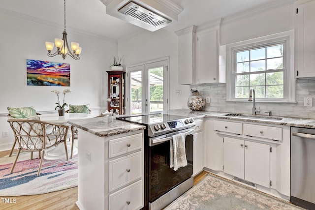 kitchen with stainless steel appliances, sink, white cabinets, light hardwood / wood-style floors, and plenty of natural light